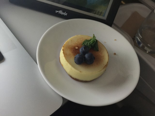 My cheesecake nestled between double-fisted electronic distraction. Photo - Bernie Leighton | AirlineReporter