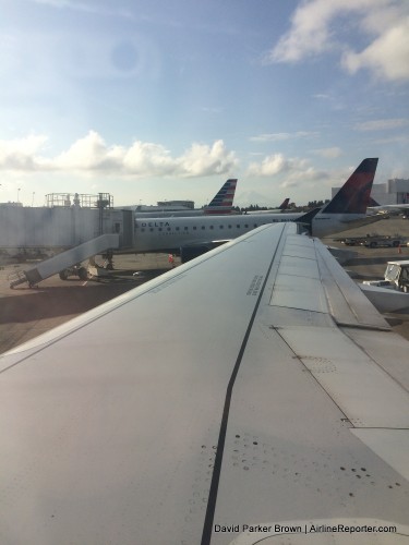A seat over the wing, looking out to the airport