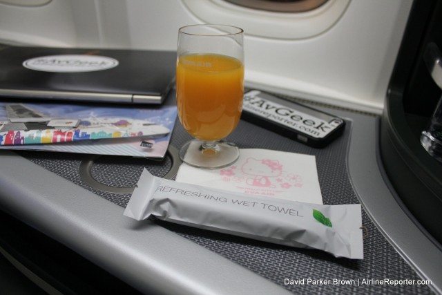 The pre-flight drink, gift for the inaugural, cold towel, and Hello Kitty napkin