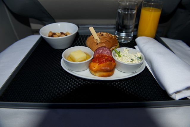 Right to left: Serbian goat's cheese with wild garlic,  (in front) corn cake with pepper sauce and salami, (Behind) Smoked chicken sandwich, and a Serbian cheese with honey. - Photo: Bernie Leighton | AirlineReporter