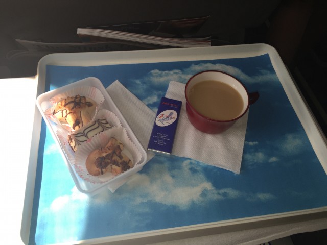 A selection of pastries, a branded chocolate bar, and some tea. - Photo: Bernie Leighton | AirlineReporter
