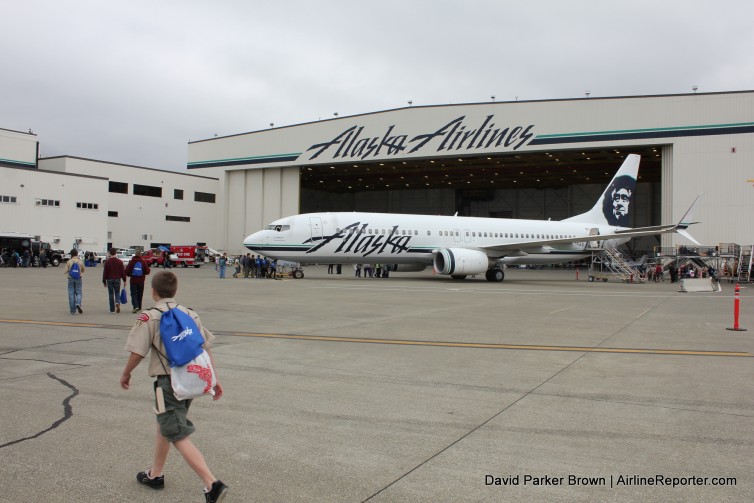 A boy scout walks by an Alaska 737 at Aviation Day