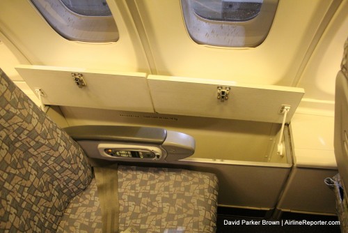 Side bins on the upper deck between the economy seat and the window