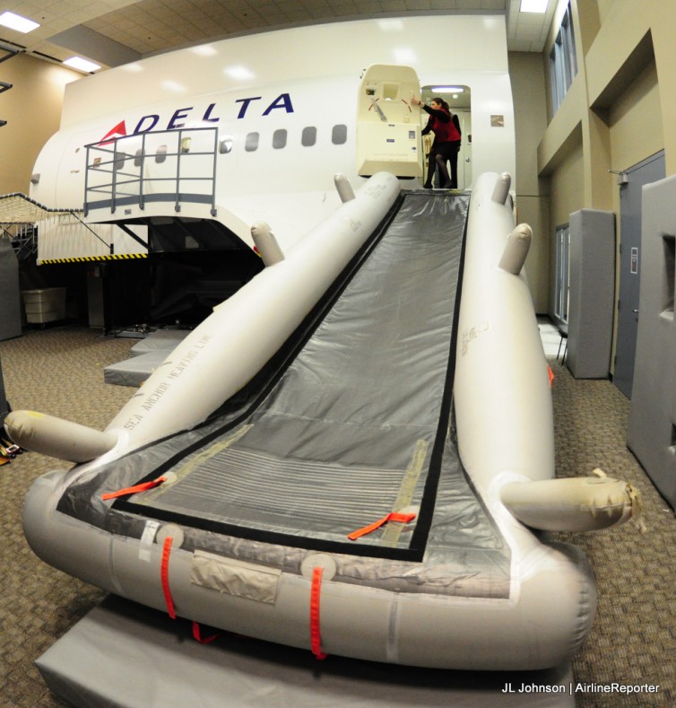 Delta's evacuation trainer, hopefully you never have to use it for real (well the trainer yes, but in a real accident, no). If things get bad, always stay calm and follow instructions. That will more likely safe you than your seat assignment.