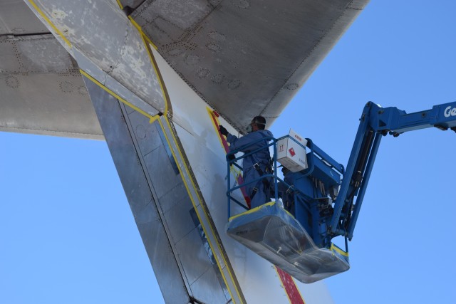 Working in three teams of two, the painters applied the red, blue, and black paint to the tail at the same time - Photo: Lauren Darnielle | AirlineReporter