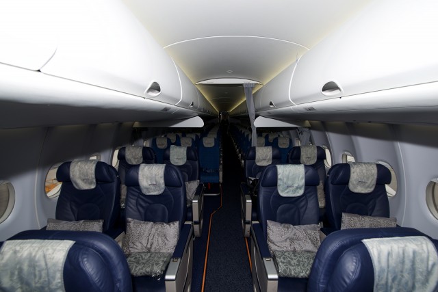 The Business Class cabin aboard a Sukhoi SSJ-100-95LR - Photo: Bernie Leighton | AirlineReporter