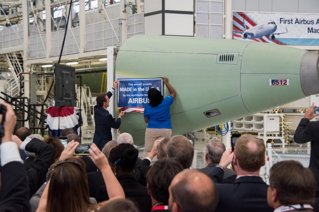 Airbus President and CEO Fabrice Brgier helped with the placement of a ceremonial placard on a component of the first aircraft to be produced in Mobile, Alabama — which reads: ”This aircraft proudly made in the U.S.A. by the worldwide team from Airbus" - Photo: Airbus