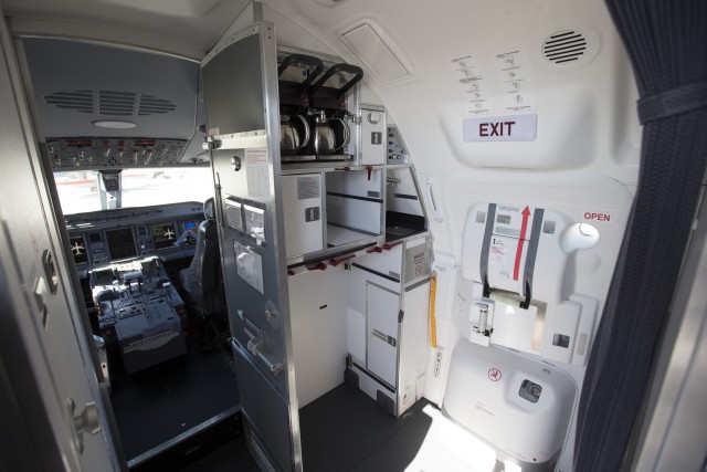 Forward galley, flight deck entrance, and lavatory onboard an American Eagle E-175 at LAX. Photo: American Airlines