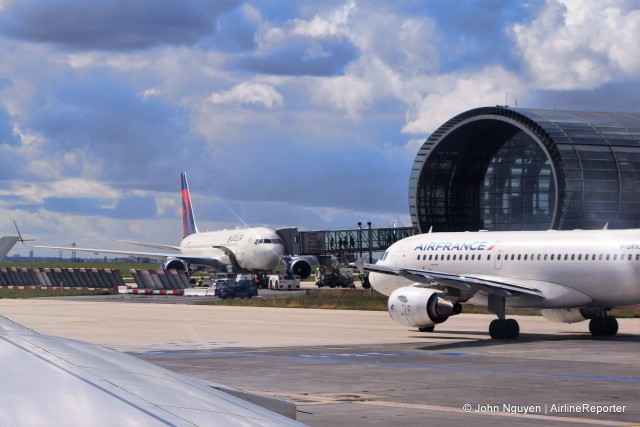 An Air France A319 passes by a Delta 767 at CDG.