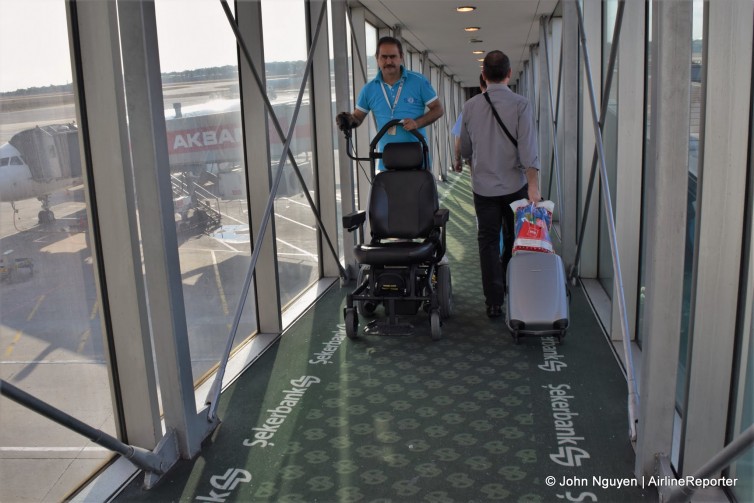 Down the jetbridge, whilst IST's clever disabled passenger trolley comes back up.