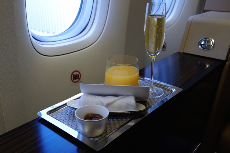 Bollinger, Orange Juice, a welcome letter, dates, and a towel - Photo: Bernie Leighton | AirlineReporter