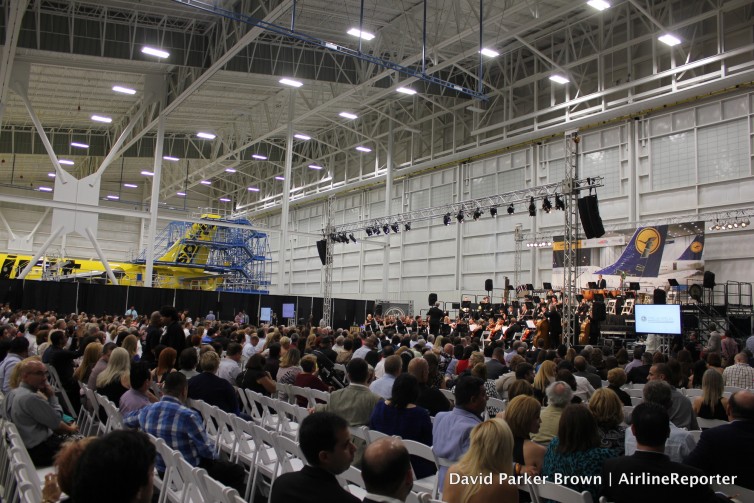 A Spirit Airlines Airbus A319 is in the background with Lufthansa Orchestra playing