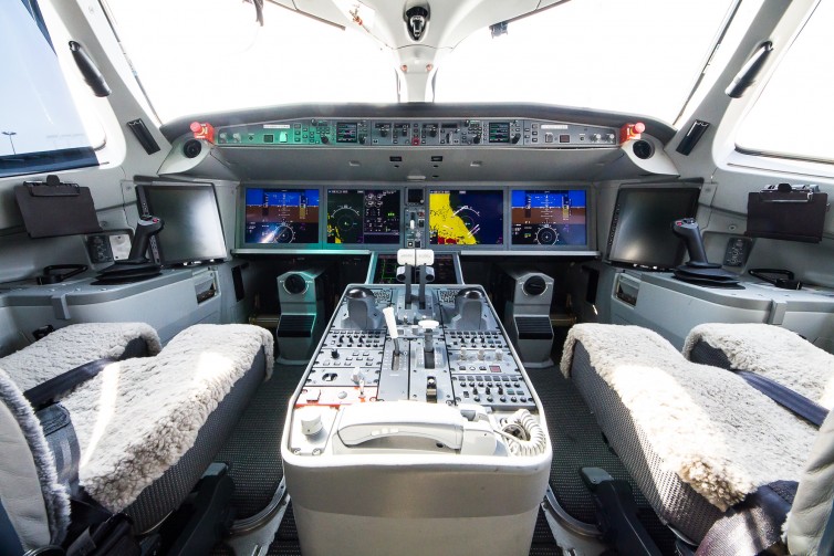 The spacious & modern cockpit of the CSeries, complete with side-sticks which is a first for Bombardier Photo: Jacob Pfleger | AirlineReporter