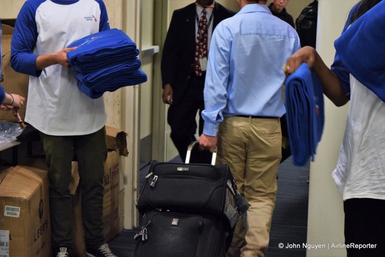 Passengers boarding the inaugural American flight to Sydney and receiving commemorative blankets.