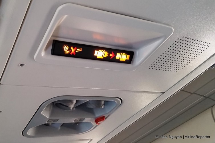 The overhead passenger service unit on an Austrian Airlines Fokker 100.
