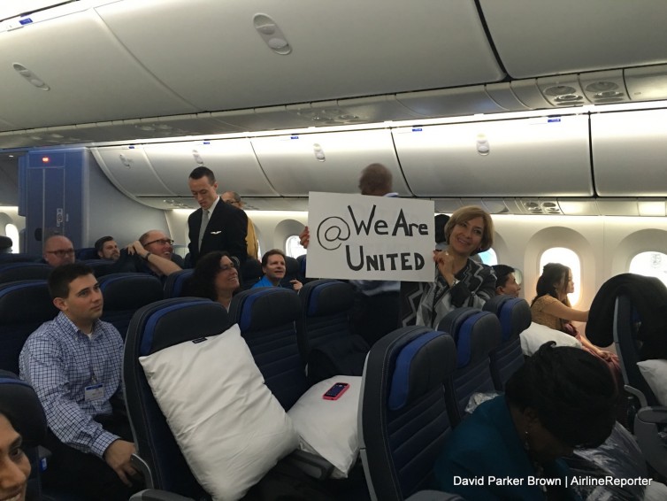 A United employee holds up a sign during the 787-9 flight
