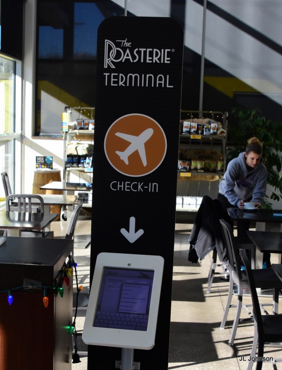 Terminal check-in kiosk at the entrance of an on-site cafe. 
