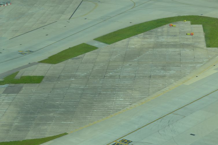 A piece of old of the old six runways blends into airfield surface - Photo: Alastair Long | AirllineReporter
