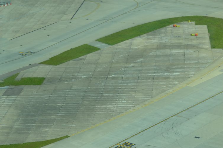 A piece of old of the old six runways blends into airfield surface - Photo: Alastair Long | AirllineReporter