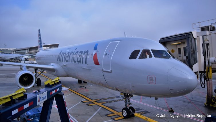 A pilot of an American Airbus A321T bound for New York waves just before pushback at LAX.