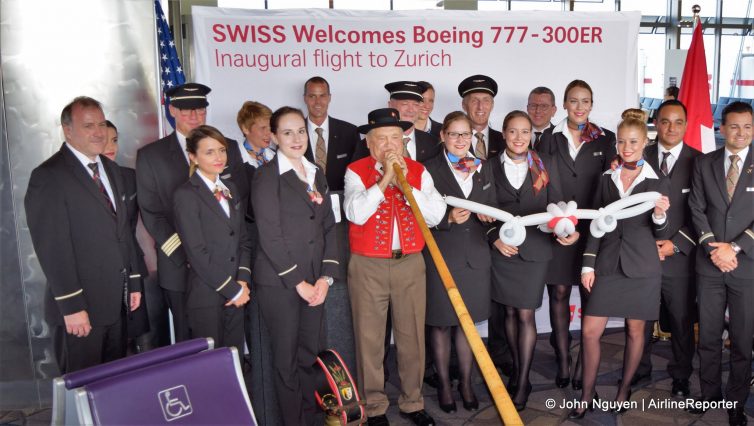 The inaugural 777-300ER crew of Swiss Flight LX 41 poses with an Alp horn.