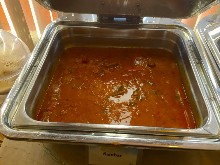 Sambar, a spicy stew made with lentils, tomatoes, and tamarind