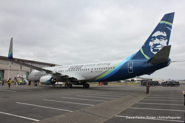 An Alaska Airlines Boeing 737-900ER with special livery sitting next to the Museum of Flight