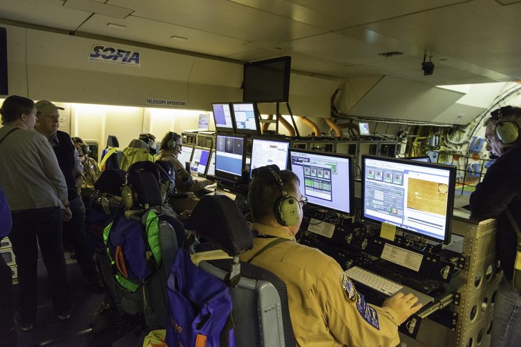 This is the instrumentation area of SOFIA, in the distance is the telescope operator's panel. The man in the hat is rockstar astronomer Dr. Ian McLean. I was starstruck! Photo: Bernie Leighton | AirlineReporter