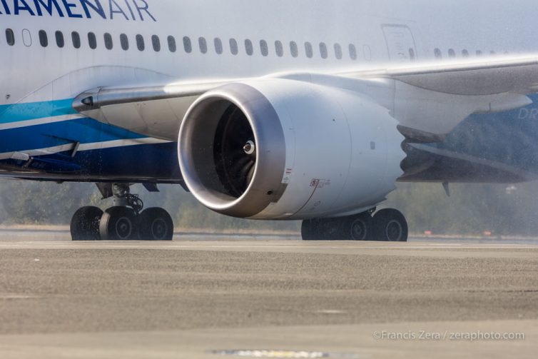 Water from the salute swirls in the jet's exhaust.