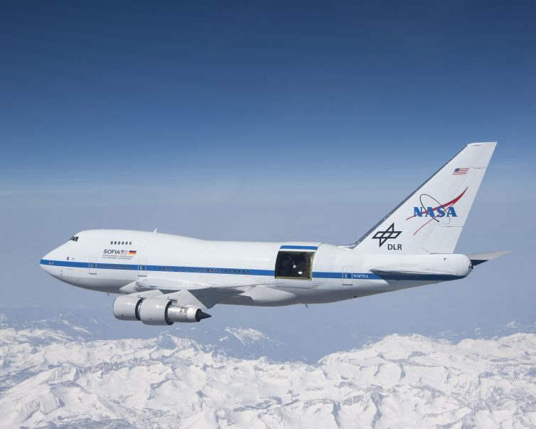 With the sliding door over its 17-ton infrared telescope wide open, NASA's Stratospheric Observatory for Infrared Astronomy ’“ or SOFIA ’“ soars over California's snow-covered Southern Sierras on a test flight in 2010 - Photo: NASA