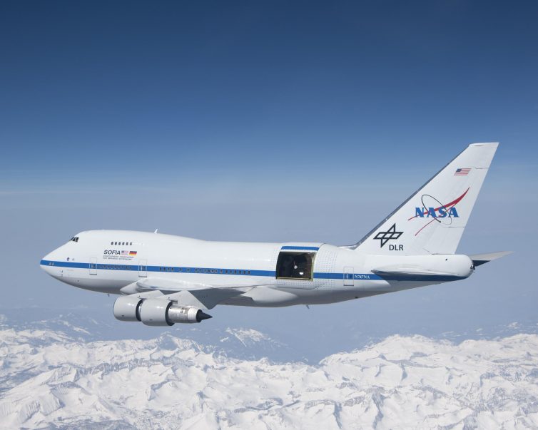With the sliding door over its 17-ton infrared telescope wide open, NASA's Stratospheric Observatory for Infrared Astronomy â€“ or SOFIA â€“ soars over California's snow-covered Southern Sierras on a test flight in 2010 - Photo: NASA