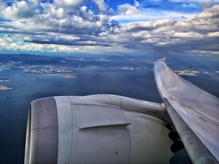 Wings flexing as we climb out over Osaka â€“ Photo: Manu Venkat | AirlineReporter