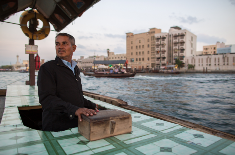 A ferry driver navigates his abra up Dubai Creek on a warm November afternoon in Dubai, UAE - Photo: Jeremy Dwyer-Lindgren