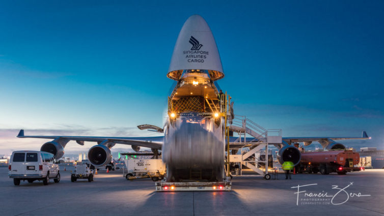 A cargo pallet is lowered away from the opened nose of an SIA Cargo 744F.