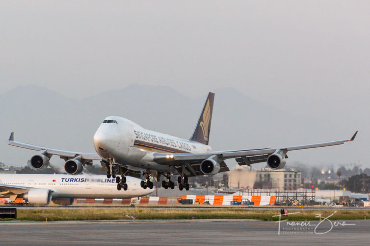 A SIA Cargo 744F, seconds before touchdown at LAX, with a Turkish Airlines 777 waiting to depart.