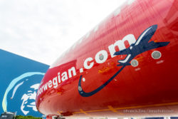 The Alaska eskimo looks on as the Norwegian jet is unloaded.