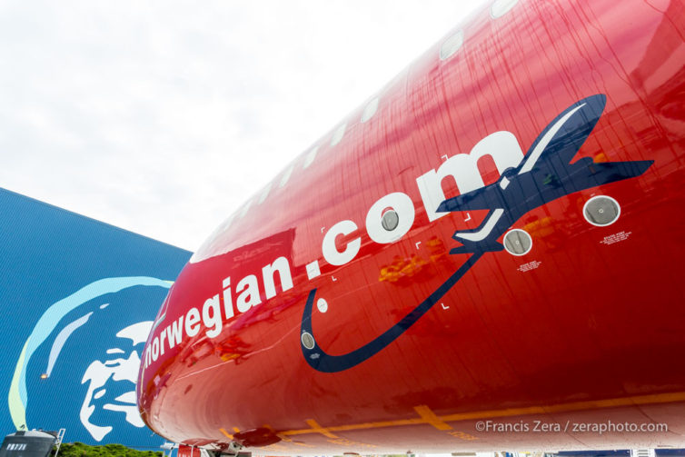 The Alaska eskimo looks on as the Norwegian jet is unloaded.