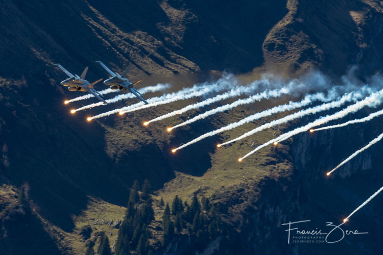 At precisely 2 p.m. (this is Switzerland after all), a pair of F/A-18s rocket up the valley spitting flares, signifying that the demo has begun.