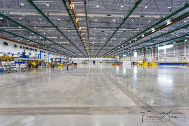 The Composite Wing Center covers more than 27 acres  equivalent to about 25 football fields. The building is 1,250 feet long, 950 feet wide, and 110 feet tall.