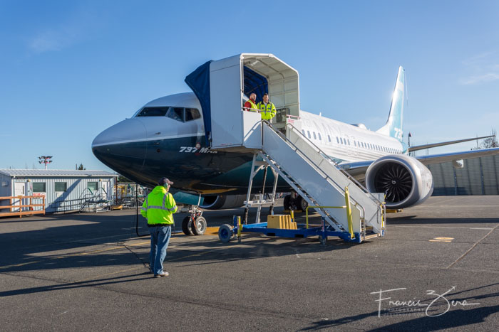 Crews prepare the jet for departure.