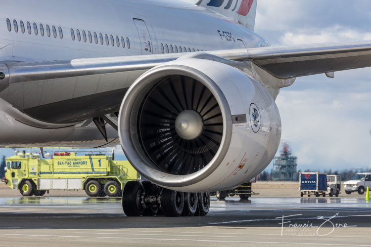 One of the jet's GE90 engines, still dripping water from the water-cannon salute