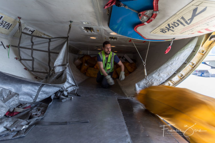 Metin Mehmedov unloads bags of mail from the inbound flight.