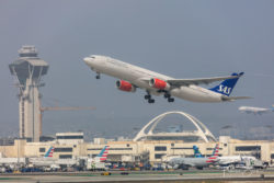 An SAS A330 departing from LAX with the iconic Theme Building and control tower, as seen from the Imperial Hill viewpoint.