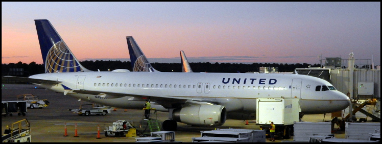 The sun just starting to rise in Houston with the morning United flights getting ready to take on passengers.