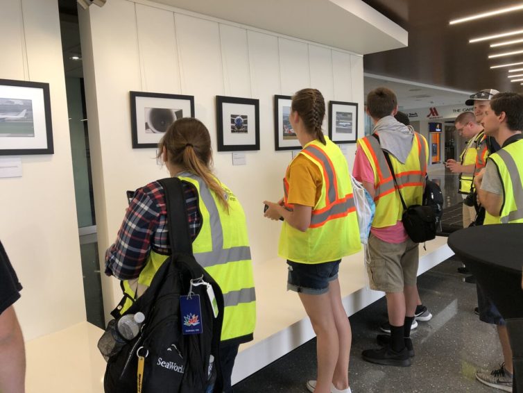 Spotters admire their framed work on public display. - Photo: TPA Airport