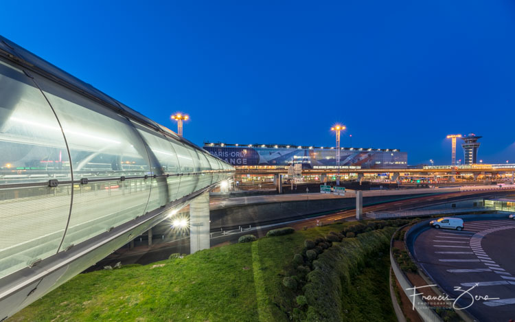 The Orly Airport terminal features a futuristic-looking pedestrian walkway