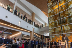 A two-story atrium features several large art pieces