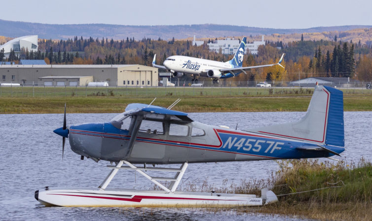 An Alaska Airlines 737 arrives behind a Cessna Skywagon. Fairbanks is one of the very few major airports where you'll find a water runway immediately adjacent to a paved one. Sharp-eyed enthusiasts may have also noticed the nose of a DC-6 below the 737 - it's mounted atop Pike's Aviator Greenhouse &amp; Sweets, and is one of several you'll encounter exploring the area.