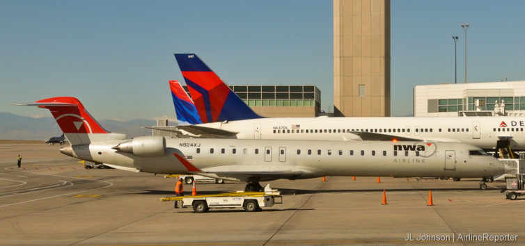 N924XJ, a Northwest CR-9 accompanies some Delta birds in Denver.