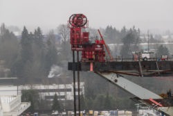 Two of the four giant strand jacks that will lift the bridge into place.